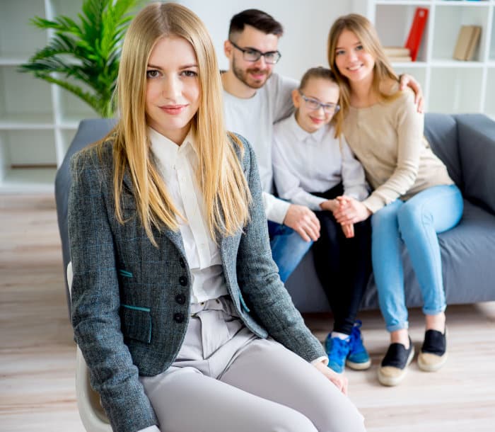 Portrait of beautiful female with family at the back