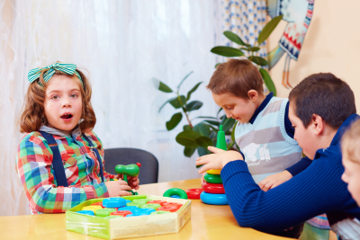 group of kids playing together in daycare center for kids with special needs