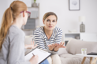 Red haired psychiatrist listening to her patient