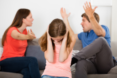 Upset Girl Covering Her Ears In Front Of Parent Having Argument
Photo Taken On: July 17th, 2016