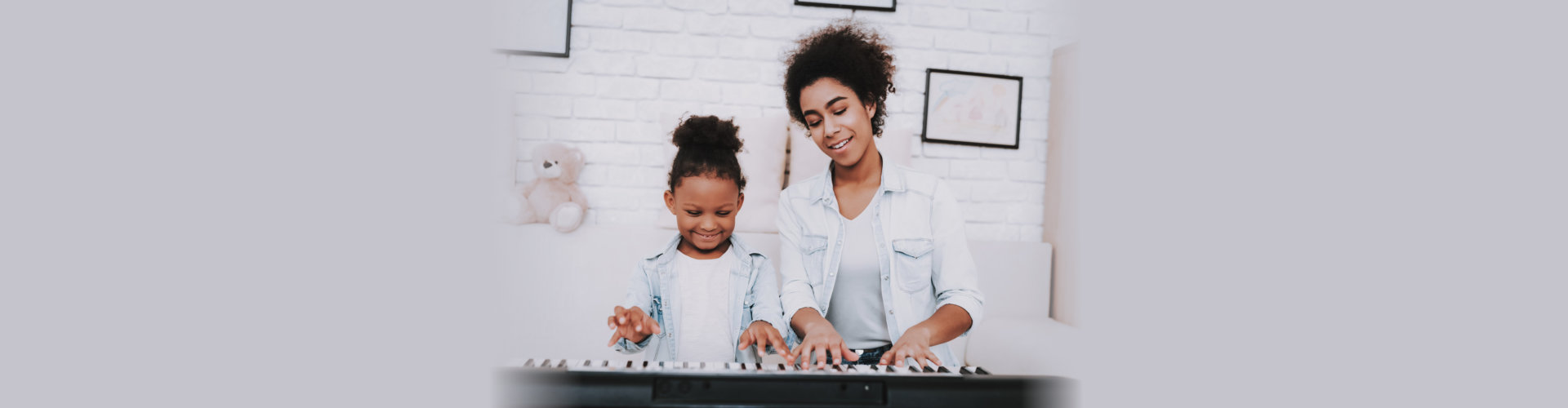 woman and child playing piano